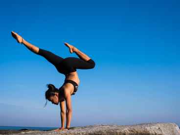 Woman With Arms Outstretched Against Blue Sky